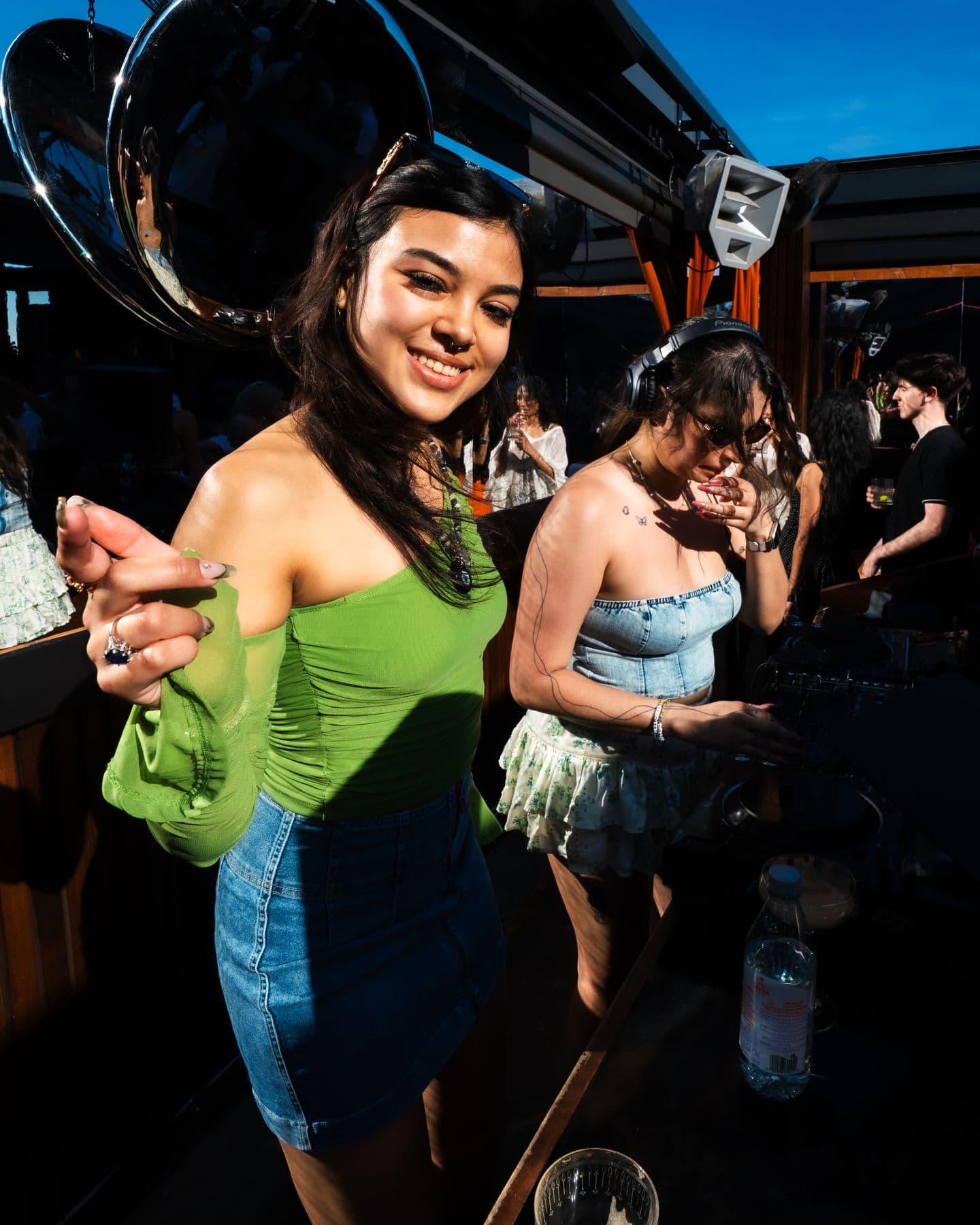 A dancer in green on the sunny roof