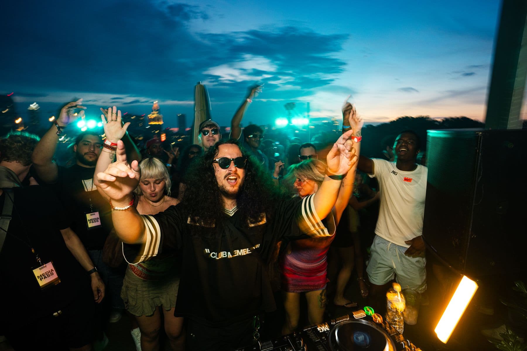 Hands up across the roof as the sun goes down