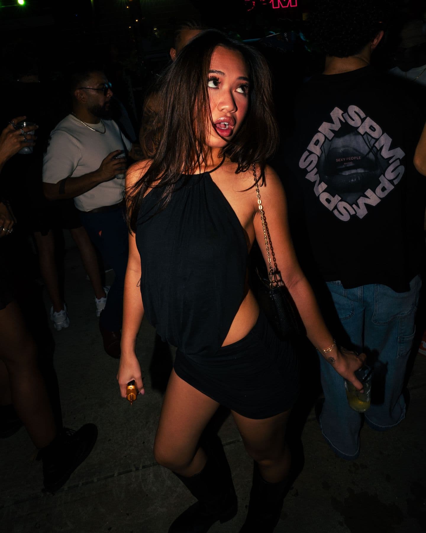 A dancer in a black dress mid-spin