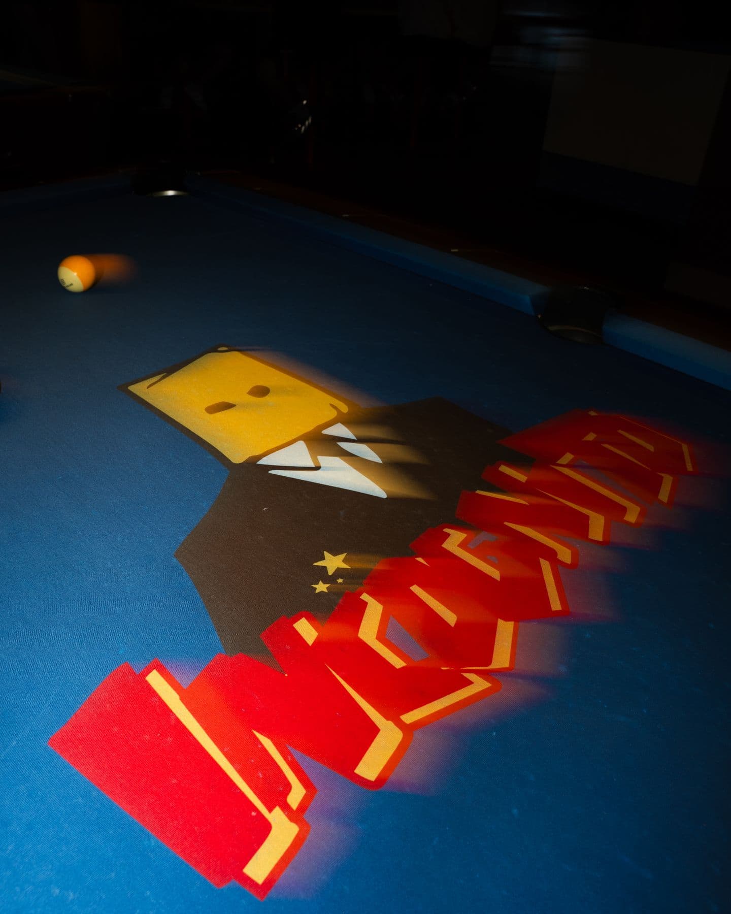 The pool table with the Incognito logo on the felt